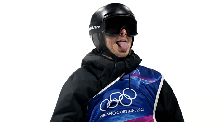 Olympic snowboarder performing aerial trick while wearing bib on one shoulder