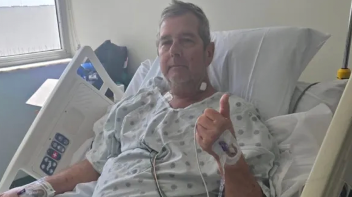Family member in emergency room, concerned expression during suspected necrotizing fasciitis crisis.