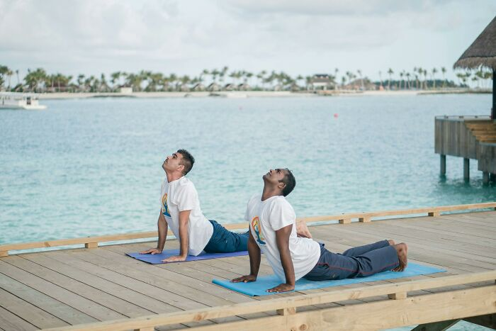 17. I was taking a walk in the park when I happened upon two men doing yoga.