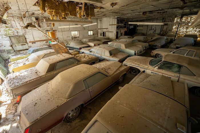 "A Collection Of Vintage Cars Forgotten Inside A Collapsing Warehouse"