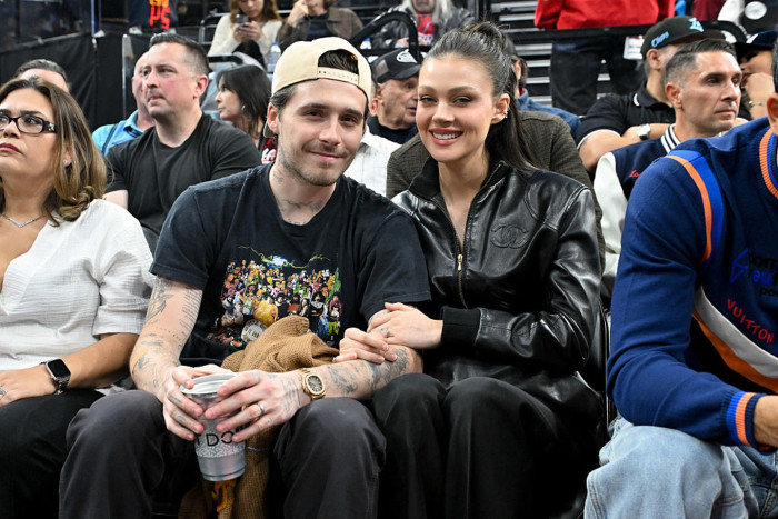 Brooklyn Beckham and Nicola Peltz at wedding event, showing couple posing.