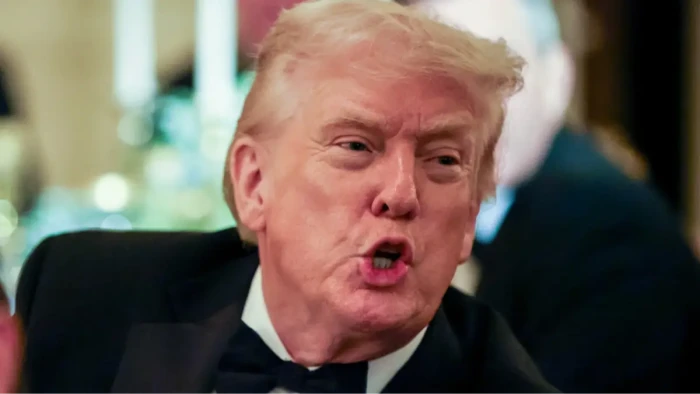 Trump speaks at a podium, criticizing Supreme Court tariff ruling and IEEPA powers