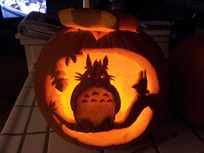 43. A cute Totoro in a tree carving