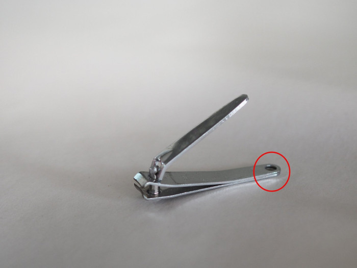 Close-up of nail clipper showing small hole in the handle