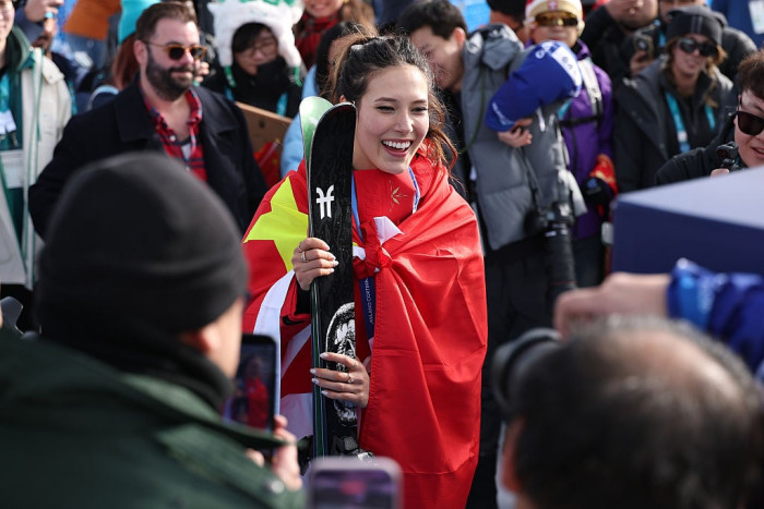Young skier Gu in winter gear, representing cultural identity and global appeal
