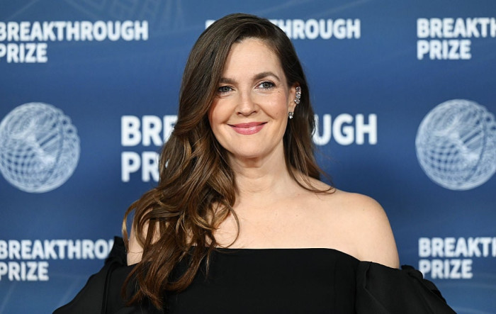 Drew Barrymore and Kaley Cuoco smiling during playful banter interview segment