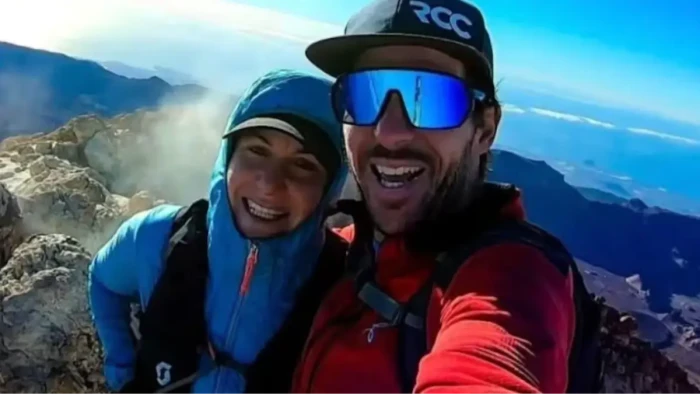 Mountain summit and hikers, referencing debate over leaving companions behind.