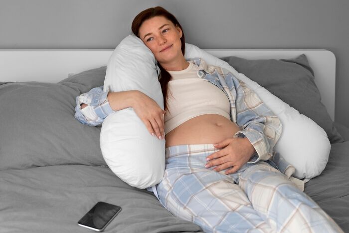 There's something unexpectedly comforting about a full-body pregnancy pillow that wraps around you.