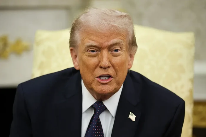 Traveler at airport terminal, checking updates during heightened U.S.-Israel tensions.