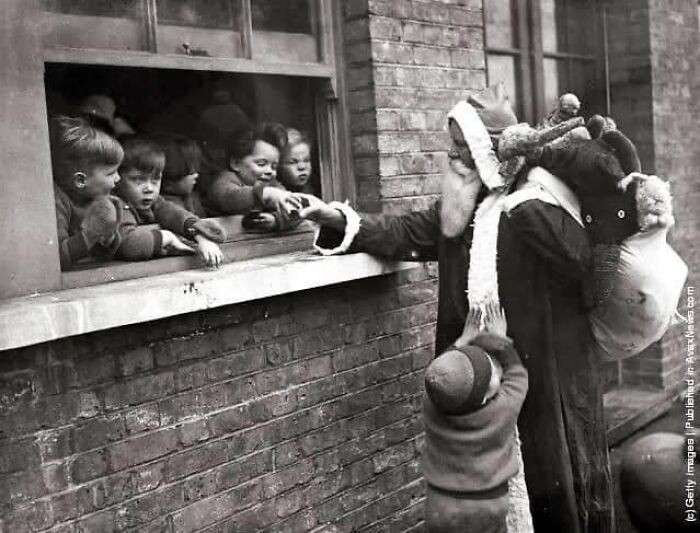 34. This 1931 photograph captures the spirit of the season as Santa delivers presents to the children of an adoption home in London.