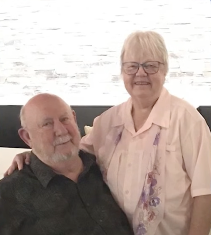 Elderly woman holding hands, somber reflection on end-of-life caregiving decision