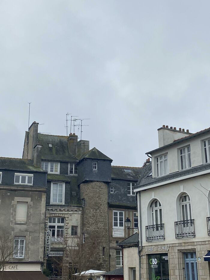 31. A tower supporting a square-shaped house above it.