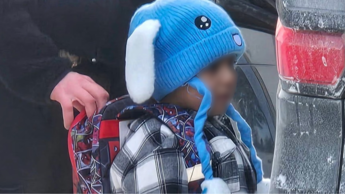 ICE officers detain children during a raid targeting students and families