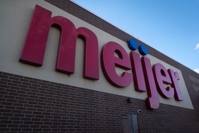 Shoppers checking canned tuna lot numbers and expiration dates during recall alert