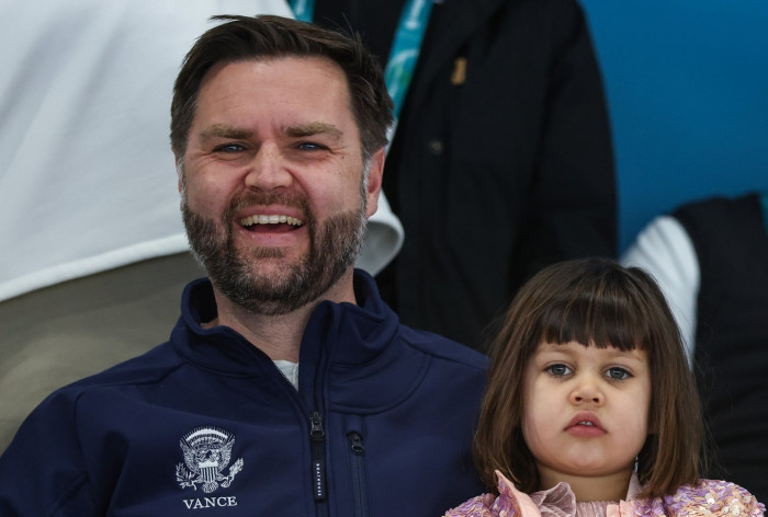 Audience members boo during Winter Olympics ceremony, political tension visible.