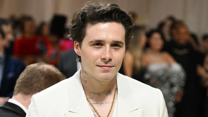 Brooklyn Beckham attending an event, reflecting on name ownership and family expectations