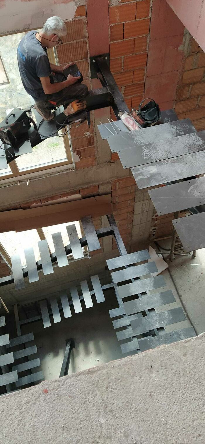 40. My Dad's Colleague Checking His Phone On The New Staircases They Built