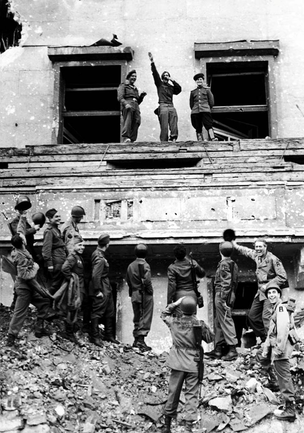 14. At the conclusion of WWII, Allied forces jest at Hitler from the vantage point of his balcony at the Reich Chancellery.