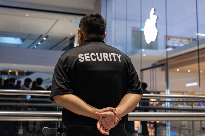 iPhone screen showing a suspicious calendar invite warning and scam alert