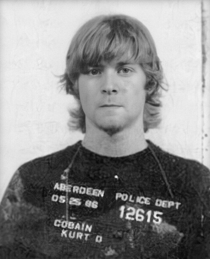 Kurt Cobain - May 1986. He ended up in handcuffs after spray-painting the strange phrase “Ain’t Got No How Watchamacallit” across several parked cars.