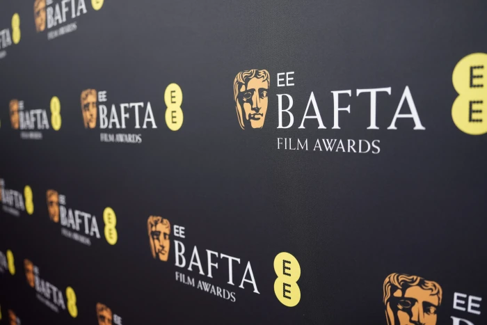 BAFTA awards stage, judges and presenters during ceremony amid inclusivity reform calls.