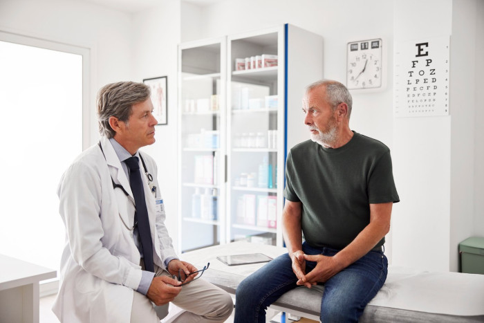 Man holding heart and pill blister pack, erectile dysfunction drugs benefits.