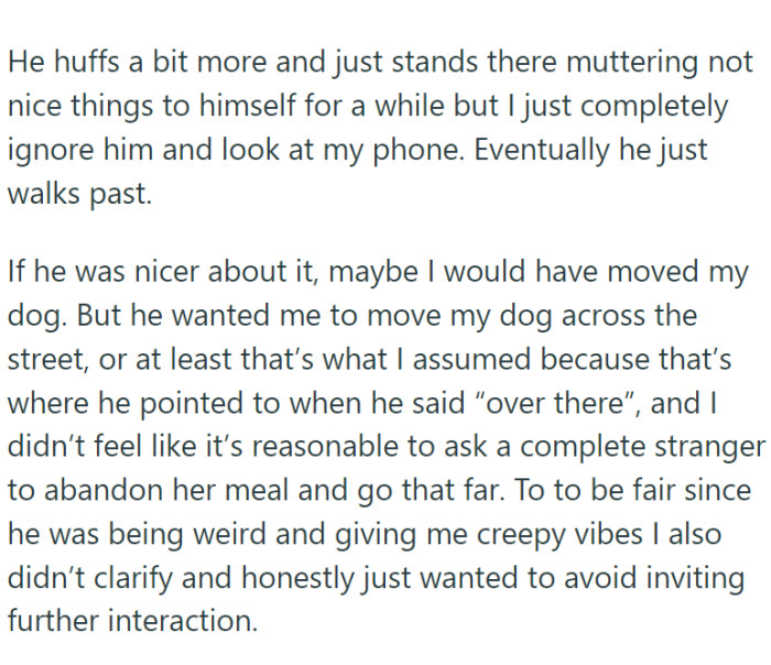Out of the blue, a man appeared and demanded that the woman move her dog because he was scared of them and wanted to pass by.