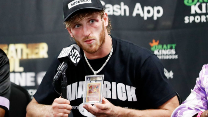 Auctioneer or collector holding a pristine Pokémon card after a record-breaking $4 million trade