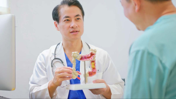 Medical professional discusses colonoscopy preparation and aftercare, including shower and meals.