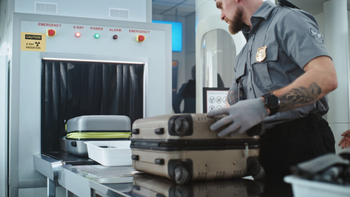Uninflated balloons and tattoo or body armor items laid out for TSA screening