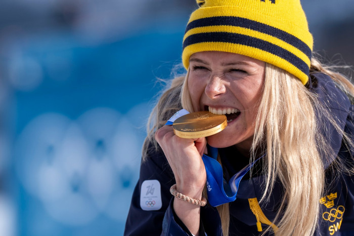 Winter Olympics medal on display, athletes debate durability concerns and replacement demands.