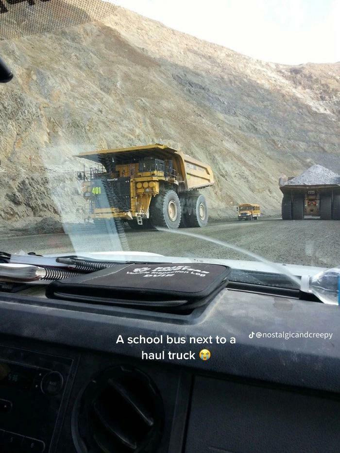 "School Bus Next To The Haul Truck"