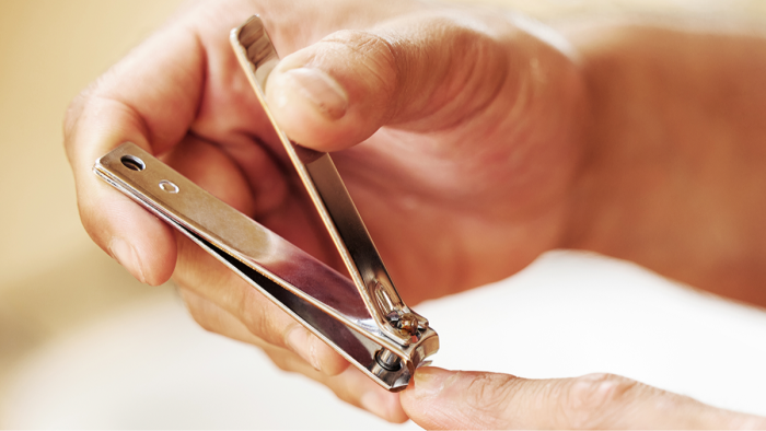 Detailed view of nail clipper hole, showing functional design for cleanliness