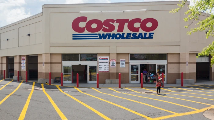 Shoppers in Costco aisle reviewing refrigerated meal kit recall health warning sign
