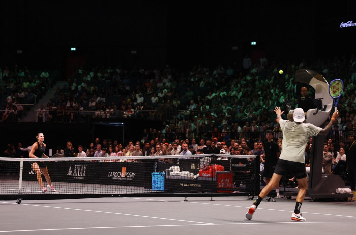 Tennis match moment contrasting gender equality themes, smaller court controversy and rule changes