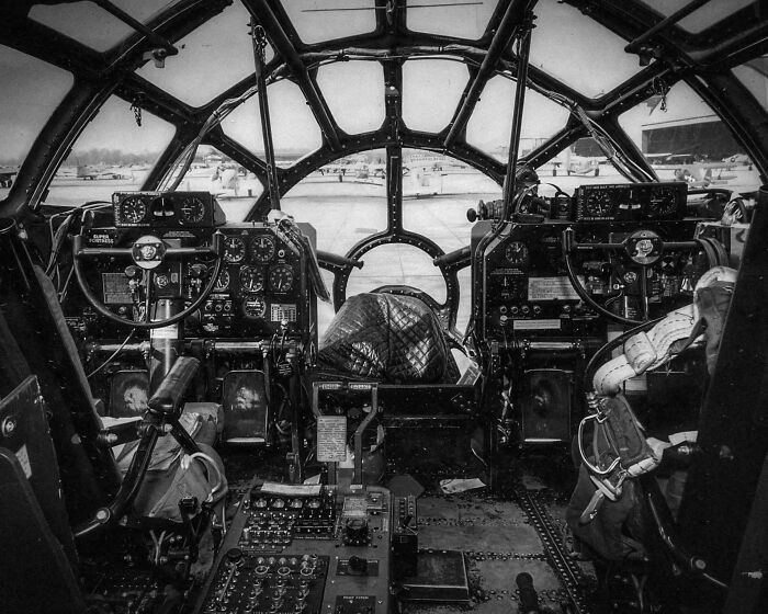 The flight deck and control panel of a B-29 Superfortress, with a protective cover placed over the bomb sight for security.