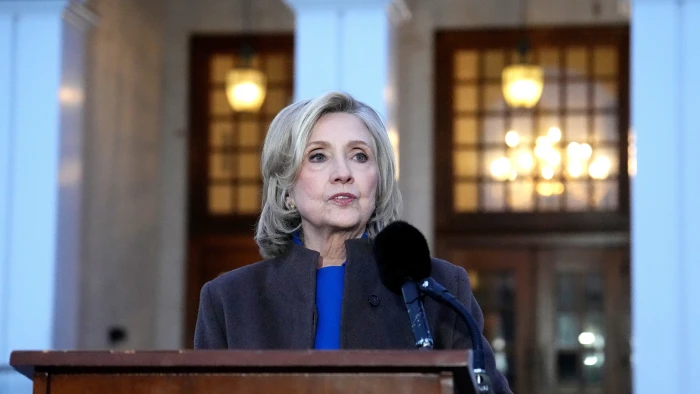 Hillary Clinton testifying at congressional hearing, paused after photograph leak investigation