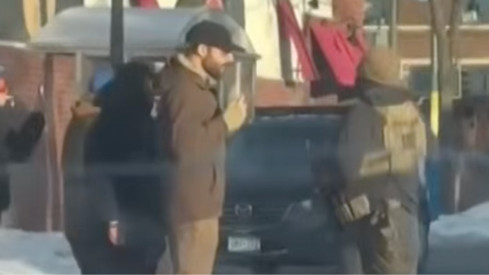 Court setting with physician testimony contrasting DHS account amid immigrant rights protests