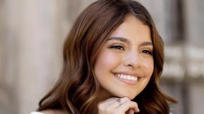 Community members gather outside a residence during search for missing teen