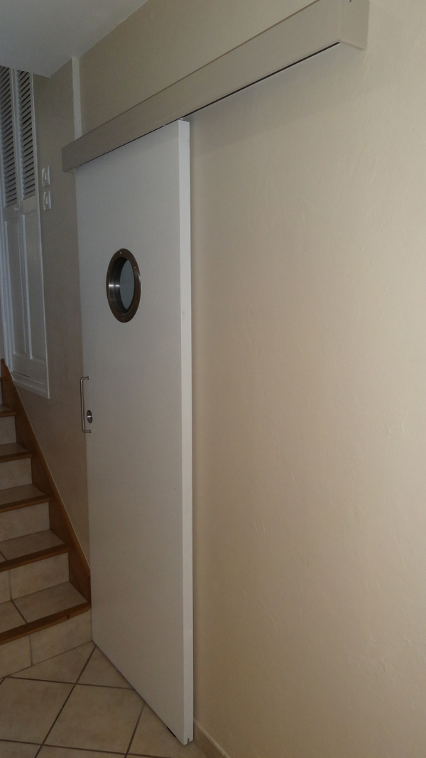 He replaced the door with a sliding one to conserve space.