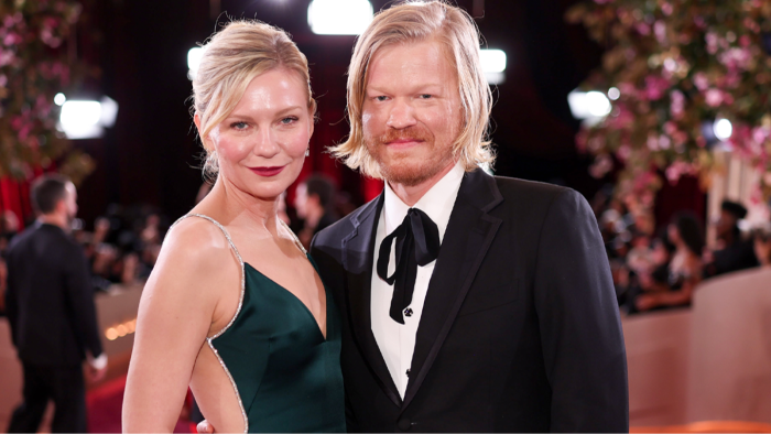 Kirsten Dunst smiling at an event, endorsing Jesse Plemons’ “Bugonia.”