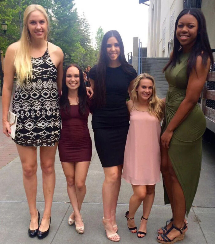 "Basketball Players Standing Next To Cheerleaders"