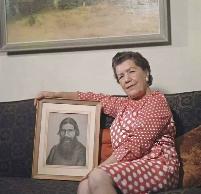 Maria Rasputina poses with a portrait of her father, Grigory Rasputin, captured in a quiet, reflective moment in 1972.