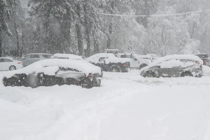 Rescuers responding at avalanche site, two hospitalized after incident, ongoing search.