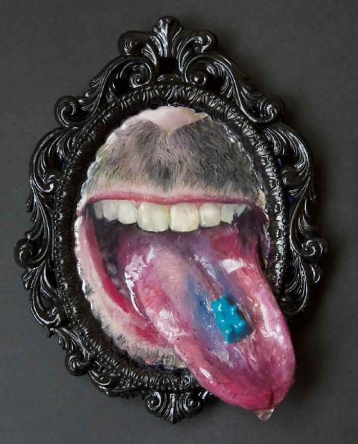 "Oil on panel, clay, modeling paste, found objects, and resin in vintage frame."
