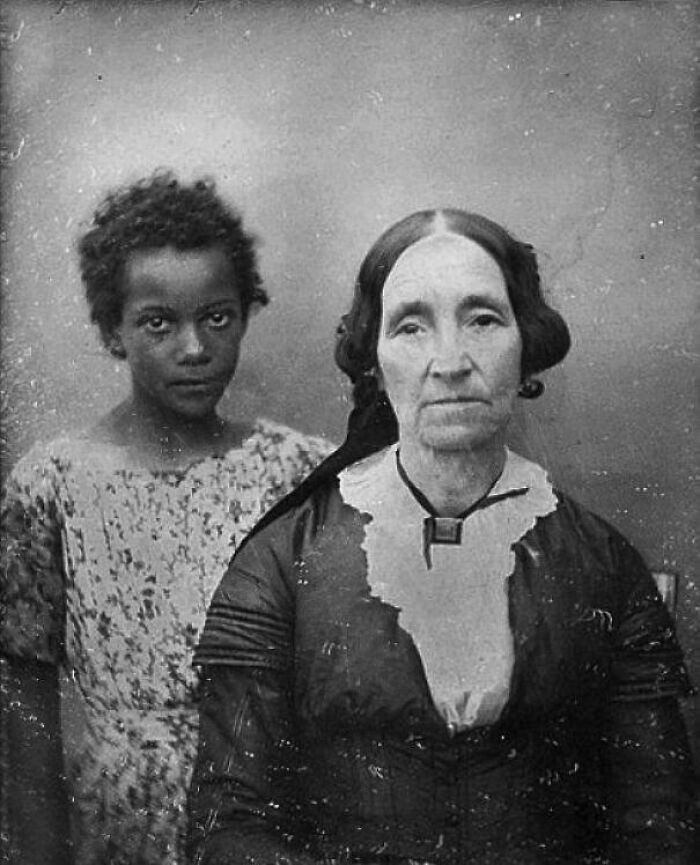 Marie Azelie Haydel, the last owner of Whitney Plantation, pictured with one of the enslaved girls who worked inside her household.