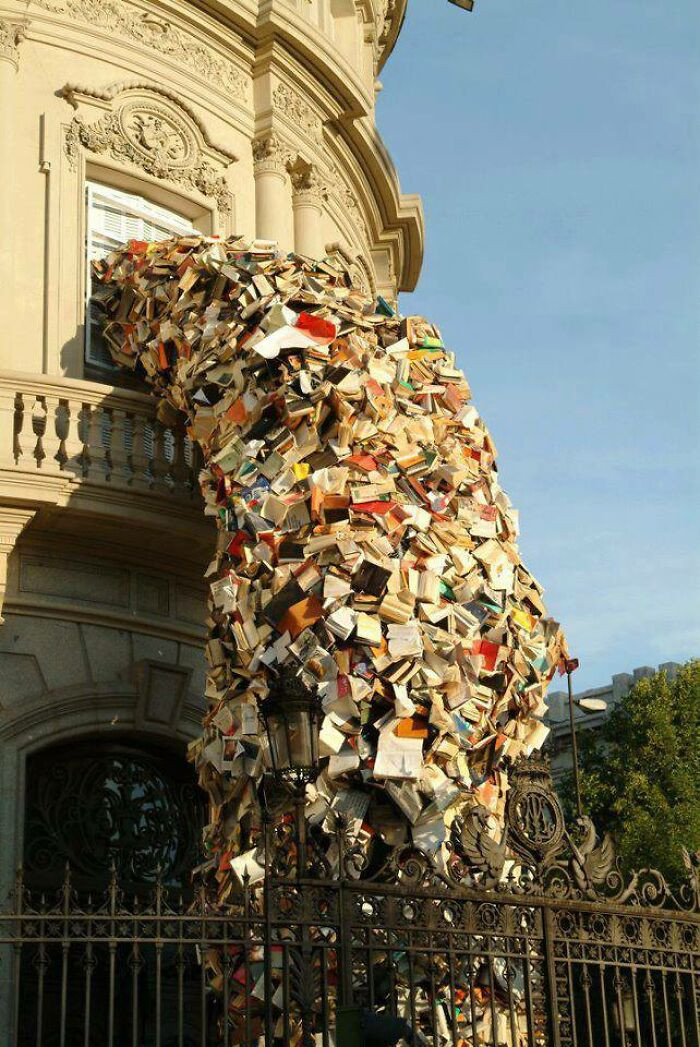 "Madrid-Based Artist Alicia Martin Transforms Thousands Of Books Into Towers That Pour Out Of Windows And Into The Streets"