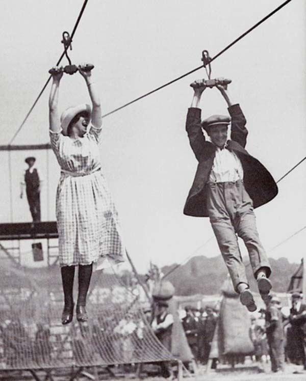 26. A couple enjoys an old-fashioned zipline at a fair (1923).