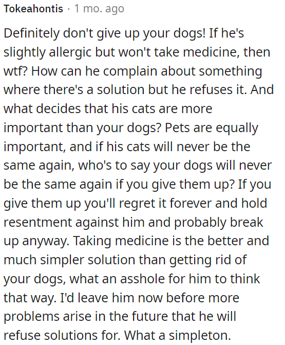 Leaving him might be a better choice than giving up her dogs due to his unwillingness to compromise.