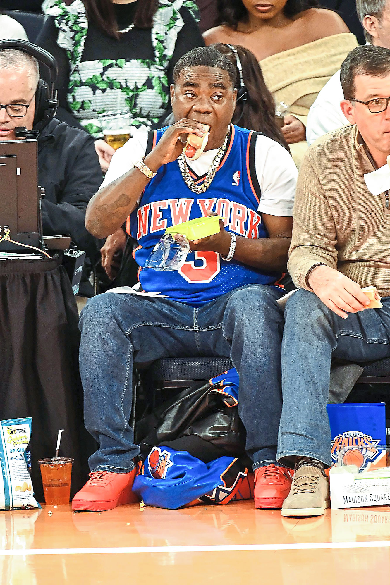 12. Tracy Morgan snacking on a hot dog at a basketball game